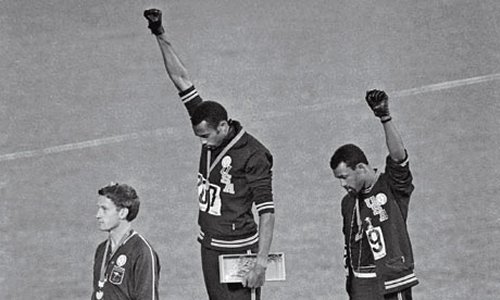  Tommie Smith and John Carlos raise their arms in a black power salute