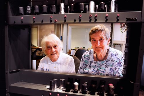 Margaret Marrs and Joyce Wheeler inspecting the reconstruction of a computer they used seven decades ago. They think the new version is “much too clean!”.